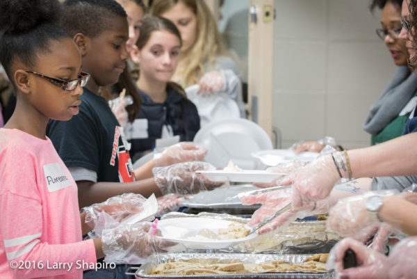 young volunteers serve Thanksgiving dinner