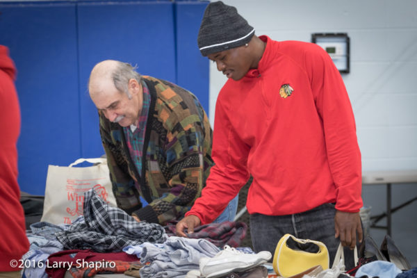 men looking through donated clothing on Thanksgiving