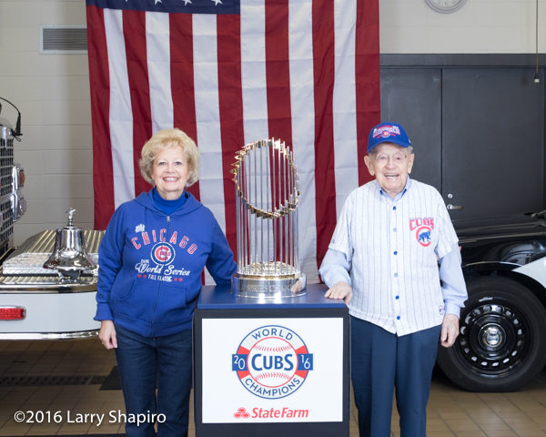 older couple posing with the world series championship trophy