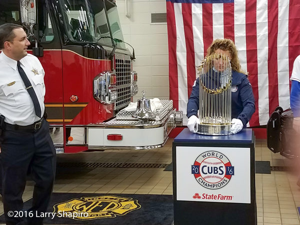 MLB handler with the world series championship trophy