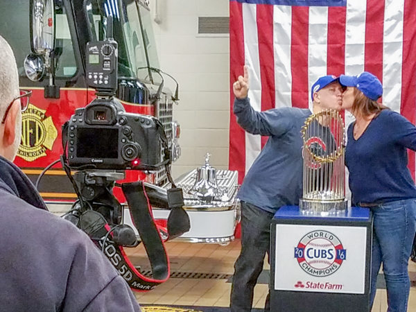 couple poses with the World Series championship trophy