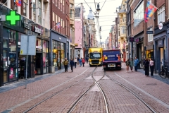 Amsterdam cobblestone street with tracks for the public tram