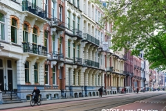 Four-story apartment buildings ling a street in Amsterdam